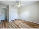 Bright bedroom with laminate flooring, a ceiling fan, and a closet with bi-fold doors at 2005 Compass Flower Way, Ocoee, FL 34761