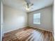 Neutral bedroom with wood flooring, a ceiling fan, and a window offering natural light at 2005 Compass Flower Way, Ocoee, FL 34761
