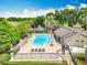 Beautiful community pool area featuring lounge chairs, lush landscaping, and a welcoming atmosphere for relaxation and recreation at 2005 Compass Flower Way, Ocoee, FL 34761