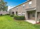 Charming exterior view with lush green lawn and neatly trimmed shrubbery, showcasing the well-maintained surroundings at 2005 Compass Flower Way, Ocoee, FL 34761
