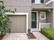 Charming townhome exterior with a one-car garage, neutral stucco, and well-maintained landscaping at 2005 Compass Flower Way, Ocoee, FL 34761