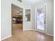 Entryway with decorative glass door leading to the open-concept living area and kitchen at 2005 Compass Flower Way, Ocoee, FL 34761