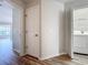 Hallway leading to laundry room and living areas at 2005 Compass Flower Way, Ocoee, FL 34761
