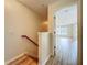 Hallway with wood-look floors leading to a living space, staircase with wood handrail at 2005 Compass Flower Way, Ocoee, FL 34761