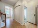 Hallway leading to the bathroom and front door, with tile floors and neutral walls at 2005 Compass Flower Way, Ocoee, FL 34761
