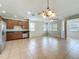 Open-concept kitchen with stainless steel appliances and tile flooring, perfect for entertaining at 2005 Compass Flower Way, Ocoee, FL 34761