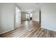 Open-concept living room with laminate floors and a doorway leading to bathroom at 2005 Compass Flower Way, Ocoee, FL 34761