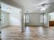 Open-concept living space with wood floors, lots of windows, and a ceiling fan at 2005 Compass Flower Way, Ocoee, FL 34761