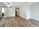 Large living room with wood flooring, a ceiling fan and neutral-toned walls at 2005 Compass Flower Way, Ocoee, FL 34761
