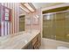 Bathroom with patterned wallpaper and a shower featuring sliding glass doors at 2060 Lamplight Cir, Mount Dora, FL 32757