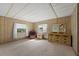 Spacious bedroom with wood paneled walls, carpet, and a large dresser with a mirror at 2060 Lamplight Cir, Mount Dora, FL 32757