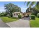 Well-maintained home featuring a carport, manicured lawn, and mature landscaping, offering great curb appeal at 2060 Lamplight Cir, Mount Dora, FL 32757
