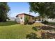 Charming manufactured home with a desert xeriscape, green lawn, and screened lanai at 2060 Lamplight Cir, Mount Dora, FL 32757