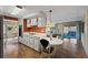 View of the kitchen with white cabinets, an adjacent breakfast nook, and a view into the living room at 2060 Lamplight Cir, Mount Dora, FL 32757