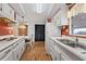 Bright kitchen with white appliances and cabinets, contrasted by a warm, reddish-brown accent wall at 2060 Lamplight Cir, Mount Dora, FL 32757