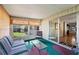 Bright sunroom with striped furniture and lots of windows at 2060 Lamplight Cir, Mount Dora, FL 32757