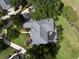 An aerial view showcases the home's roof, screened-in pool, landscaping, and overall property layout at 2106 Ridgewind Way, Windermere, FL 34786