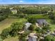 Expansive aerial view of a beautiful home surrounded by lush greenery and a serene landscape at 2106 Ridgewind Way, Windermere, FL 34786