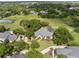 Aerial view showing a home with an expansive yard, mature trees, and a pool with screened enclosure at 2106 Ridgewind Way, Windermere, FL 34786