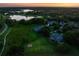 An aerial view of the property features lush landscaping, a lake view, and a serene neighborhood at 2106 Ridgewind Way, Windermere, FL 34786