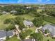 Stunning aerial shot showcasing a home nestled among mature trees and manicured lawns at 2106 Ridgewind Way, Windermere, FL 34786