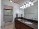 Bright bathroom featuring double sinks with granite countertops, a tub and tiled floors at 2106 Ridgewind Way, Windermere, FL 34786