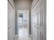 Hallway leading to a spa-like bathroom with a soaking tub and glass block window at 2106 Ridgewind Way, Windermere, FL 34786