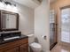 Bathroom features a granite-top sink, walk-in shower, and travertine tile at 2106 Ridgewind Way, Windermere, FL 34786