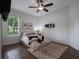 Well-lit bedroom with hardwood floors, a ceiling fan, and a large window view at 2106 Ridgewind Way, Windermere, FL 34786