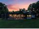 Exterior view of home showcasing the screened lanai, pool, and lush landscaping at 2106 Ridgewind Way, Windermere, FL 34786