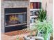 Close-up of the fireplace with a stone hearth and a glass screen at 2106 Ridgewind Way, Windermere, FL 34786