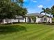 Stunning home exterior with a manicured lawn, mature trees, and a grand entrance at 2106 Ridgewind Way, Windermere, FL 34786
