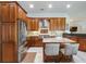 Gourmet kitchen with custom wood cabinetry, granite countertops, and stainless steel appliances at 2106 Ridgewind Way, Windermere, FL 34786