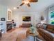 Cozy living room with fireplace, and a leather sofa at 2106 Ridgewind Way, Windermere, FL 34786