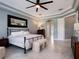 Spacious main bedroom with tile floors, tray ceilings, and access to the main bathroom at 2106 Ridgewind Way, Windermere, FL 34786