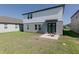 Spacious backyard featuring a patio with outdoor seating and lush green grass at 2363 Lancashire St, Davenport, FL 33896