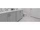 Bathroom featuring a double vanity with sleek hardware and a white countertop at 2363 Lancashire St, Davenport, FL 33896