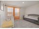 Bright bedroom showcasing a white crib, daybed, and orange patterned window coverings at 2363 Lancashire St, Davenport, FL 33896