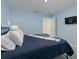 Serene bedroom featuring cozy bedding, soft pillows, and a wall-mounted TV for a relaxing stay at 2363 Lancashire St, Davenport, FL 33896