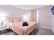 Inviting bedroom featuring a bed with soft pillows, a TV, and a convenient bedside table with a lamp at 2363 Lancashire St, Davenport, FL 33896