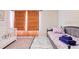 Cozy bedroom with a white crib, daybed, and colorful striped rug at 2363 Lancashire St, Davenport, FL 33896