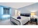 Relaxing bedroom with a comfortable bed, stylish bedside table, and ample natural light from the window at 2363 Lancashire St, Davenport, FL 33896