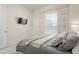 Inviting bedroom with a plush bed, soft lighting, and a mounted television at 2363 Lancashire St, Davenport, FL 33896