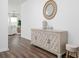 Inviting entryway with wood floors, stylish cabinet, decorative mirror, and stool at 2363 Lancashire St, Davenport, FL 33896