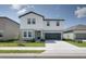 Charming two-story home with a well-manicured lawn and two-car garage in a suburban neighborhood at 2363 Lancashire St, Davenport, FL 33896
