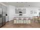 Modern kitchen with stainless steel appliances, island with seating, and hardwood floors at 2363 Lancashire St, Davenport, FL 33896