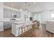 Modern kitchen with stainless steel appliances, island with seating, and hardwood floors at 2363 Lancashire St, Davenport, FL 33896