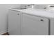 Laundry room featuring a white front load washing machine and dryer at 2363 Lancashire St, Davenport, FL 33896