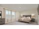 Bright main bedroom featuring a stylish bed, dresser, and bedside lamps at 2363 Lancashire St, Davenport, FL 33896