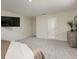 Spacious bedroom featuring a TV, dresser and an open entry to the bathroom at 2363 Lancashire St, Davenport, FL 33896